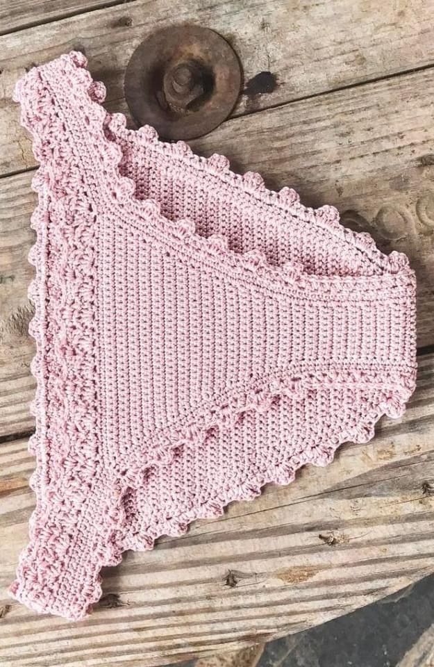 a pink crocheted dishcloth on a wooden surface