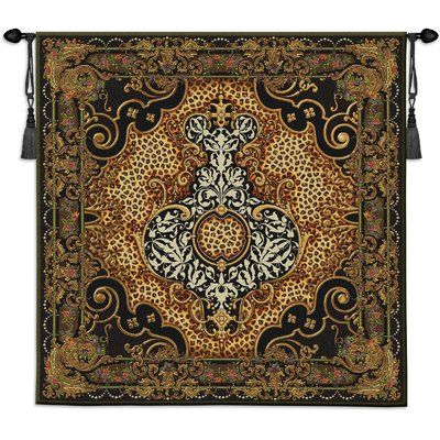 a tapestry hanging on the wall with black and gold accents, including an ornate design