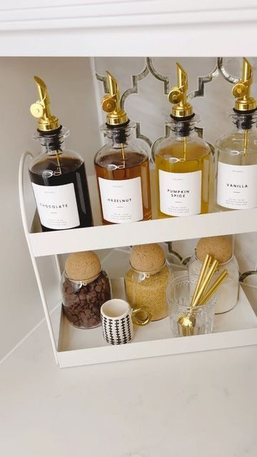 an open cabinet filled with different types of perfumes and other items in bottles on the shelves