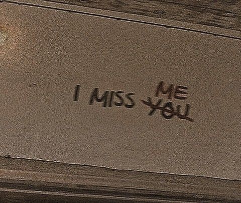 graffiti on the side of a building that says i miss you written in black ink