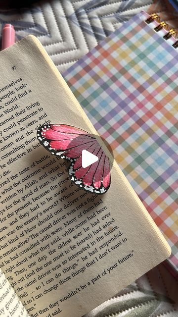 a butterfly sitting on top of an open book