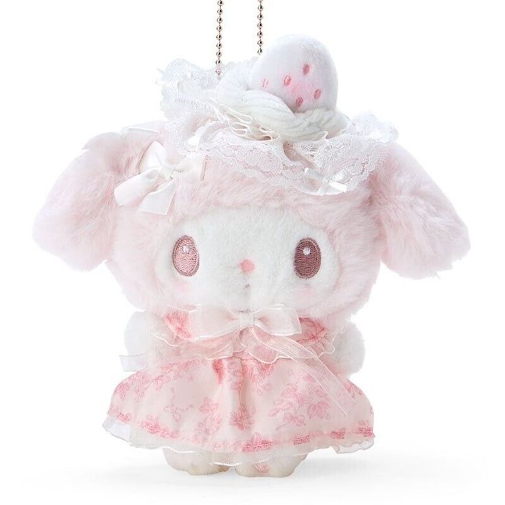 a small stuffed animal wearing a pink dress