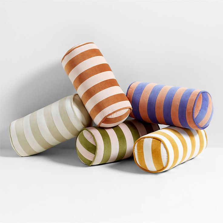 five striped vases stacked on top of each other in the shape of cones, all different colors and sizes