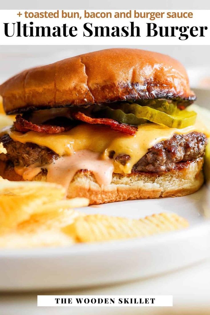 a cheeseburger with bacon and burger sauce on a plate next to potato chips