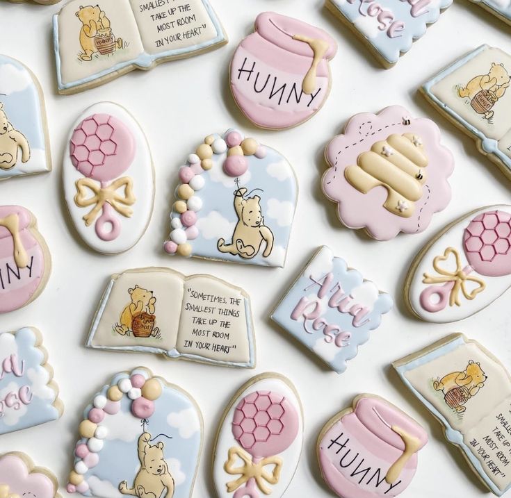 some cookies are decorated with winnie the pooh characters and words that spell out their names