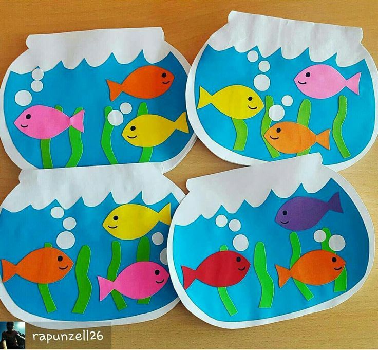 four paper plates with fish in the water and bubbles on them, sitting on a table