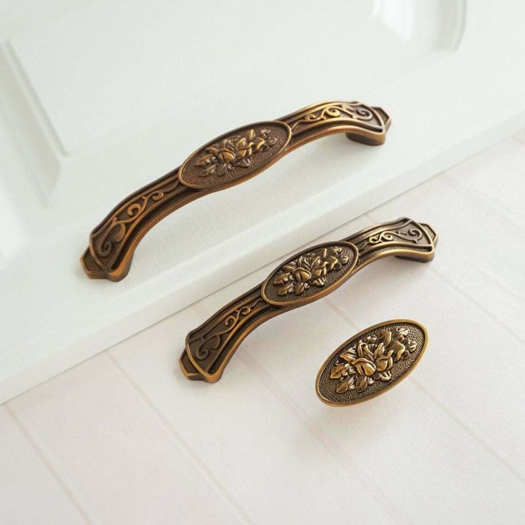 two antique style handles on a white counter