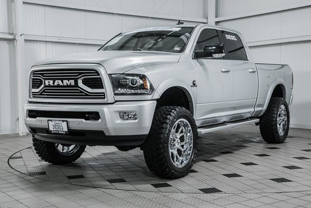 a white ram truck is parked in a large room with black and white checkered flooring