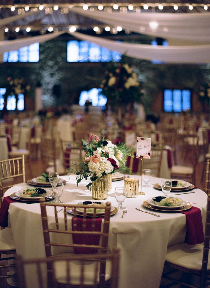 the tables are set with white linens and place settings