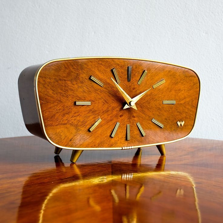 a wooden clock sitting on top of a table