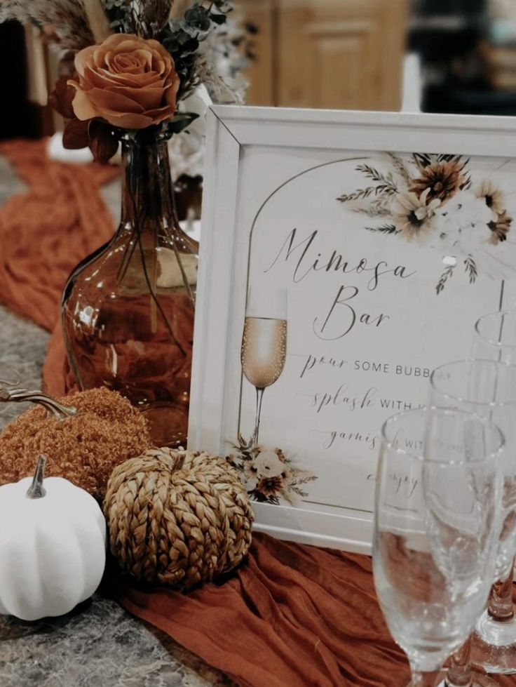 a table topped with wine glasses and a sign