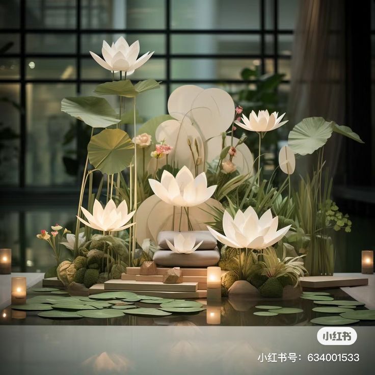 there are many white flowers in the center of this table with water lilies on it