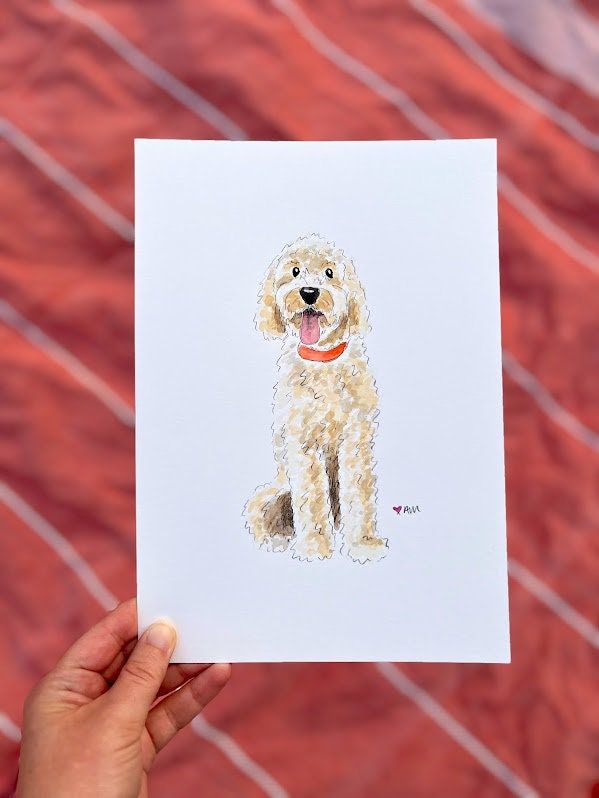 a person holding up a card with a drawing of a dog