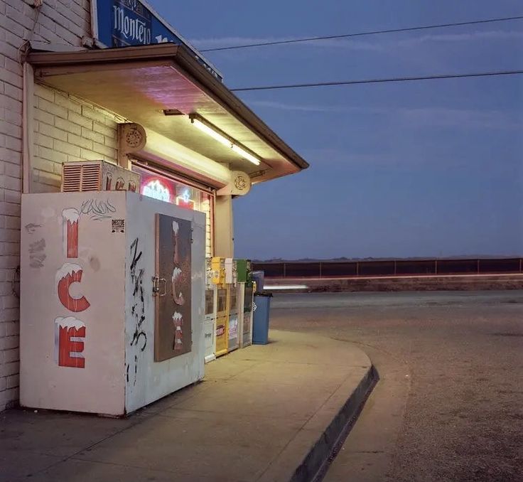 a vending machine sitting in front of a building