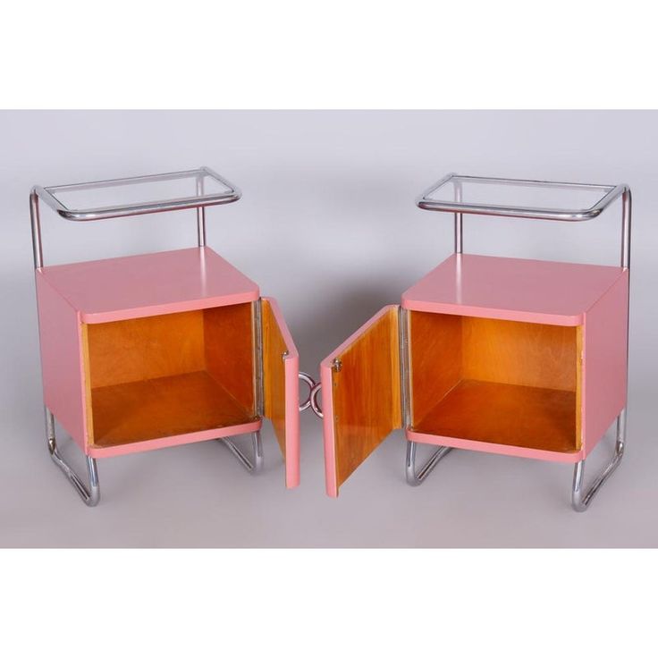 two pink and chrome side tables with open doors on each side, one is turned over