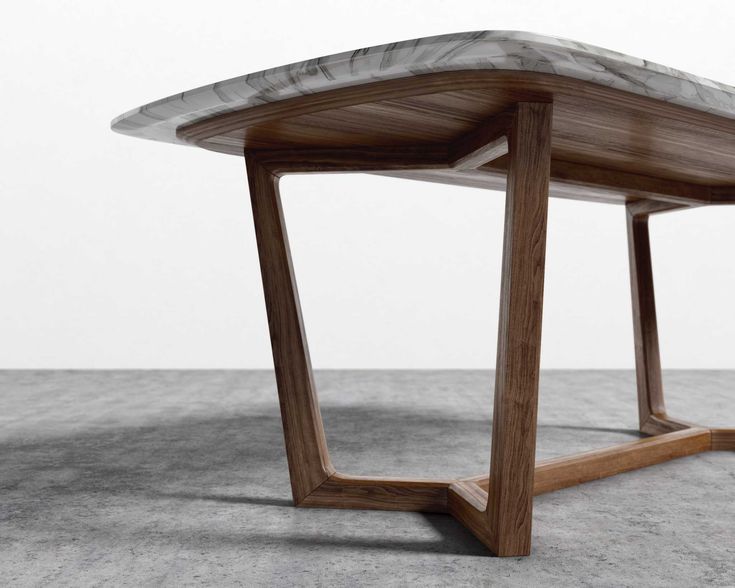 a wooden table sitting on top of a cement floor