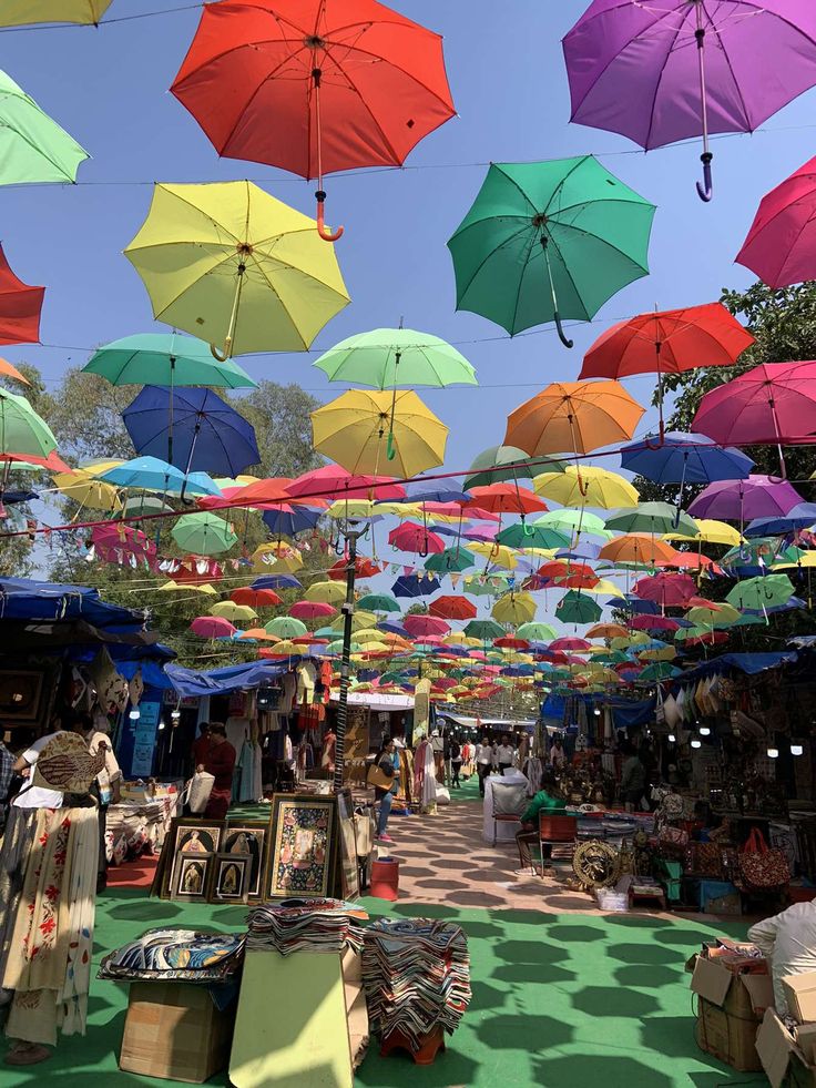 many colorful umbrellas are hanging in the air