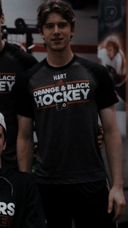 two men in black shirts standing next to each other