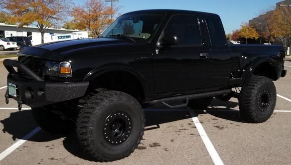 a black pickup truck parked in a parking lot