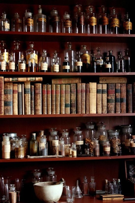 many old books and jars are on the shelves