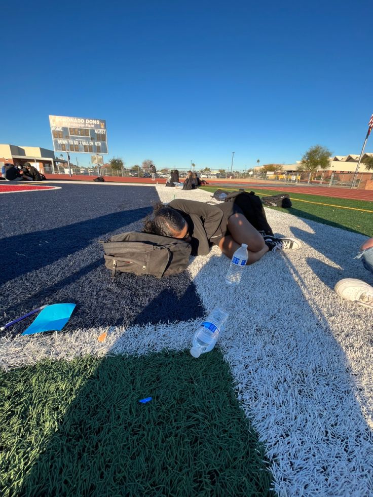 a person laying on the ground with water bottles