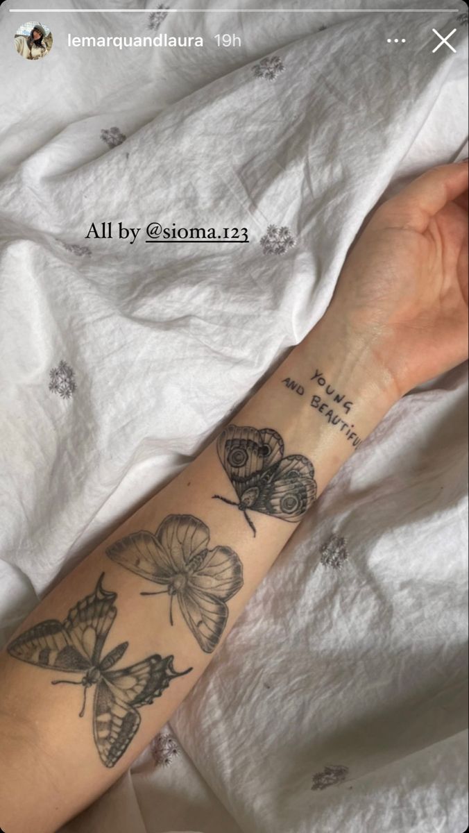 a woman's arm with butterflies on it and the words, all by person