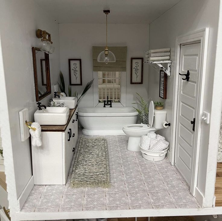 a doll house bathroom with sink, toilet and bathtub in the middle of it