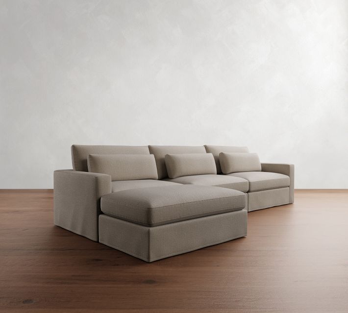 a couch sitting on top of a hard wood floor next to a white wall in an empty room