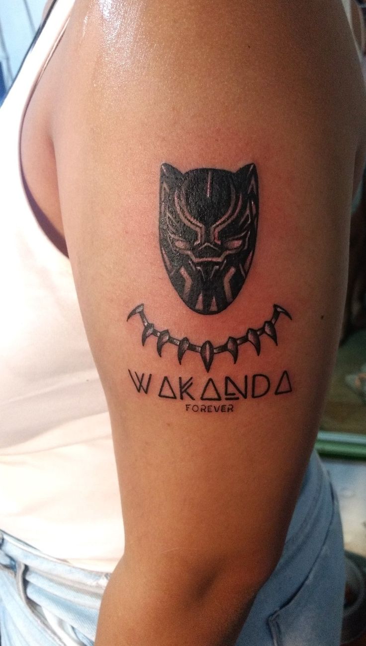 a woman with a tattoo on her arm that reads wakaandaa, forever