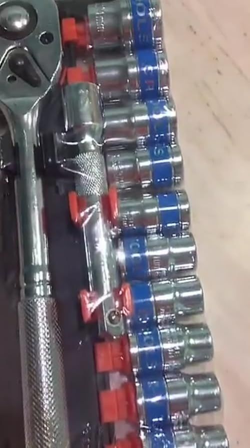 the wrench is sitting on top of some batteries