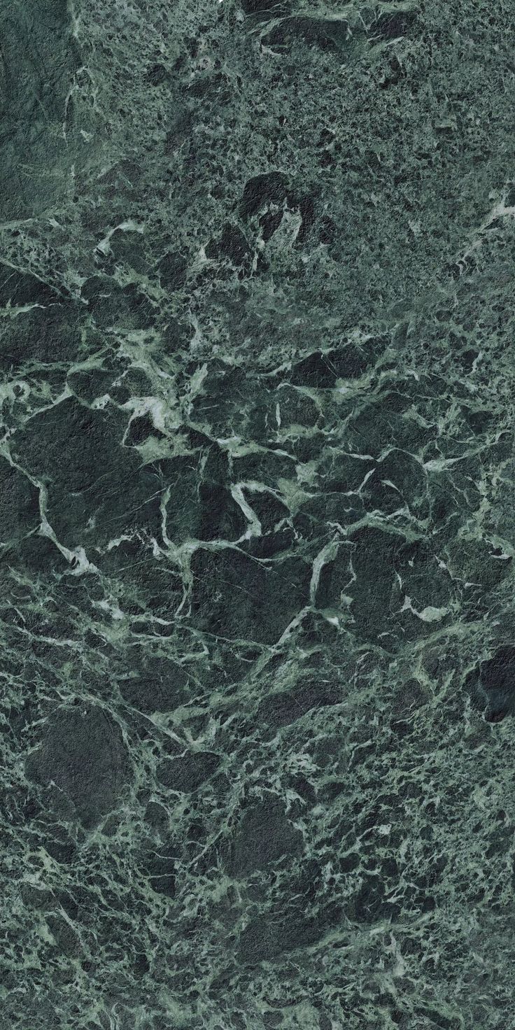 a green marble textured surface with black and white swirls