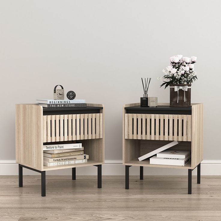 two side tables with books and vases on them