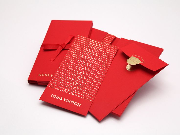 three red envelopes with a gold brooch on each one that says louis villion