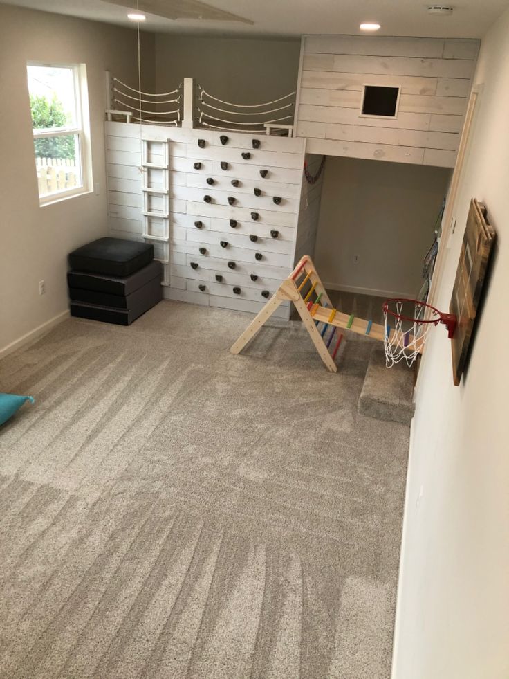 Grey, white, climbing wall with shiplap, hideout, loft, reading book Loft Fort Ideas, Tiny Home Playroom, Playroom Ideas Climbing Wall, Barndominium Playroom, Playroom Fort Loft, Playroom Fort Ideas, Indoor Play Loft, Indoor Loft Playhouse, Rustic Playroom Ideas