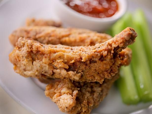 fried chicken and vegetables on a plate with dipping sauce