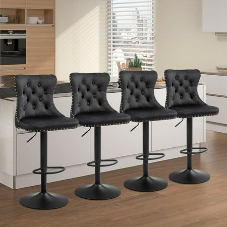 three black leather bar stools in a kitchen