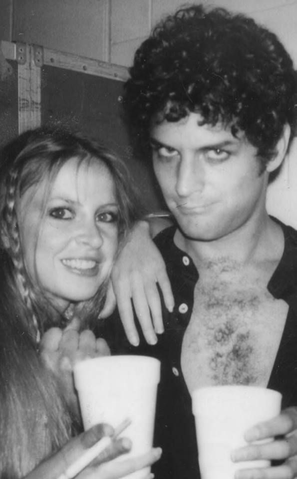 black and white photograph of two people holding cups