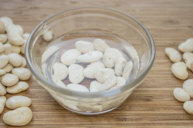 white beans in a glass bowl on a wooden table