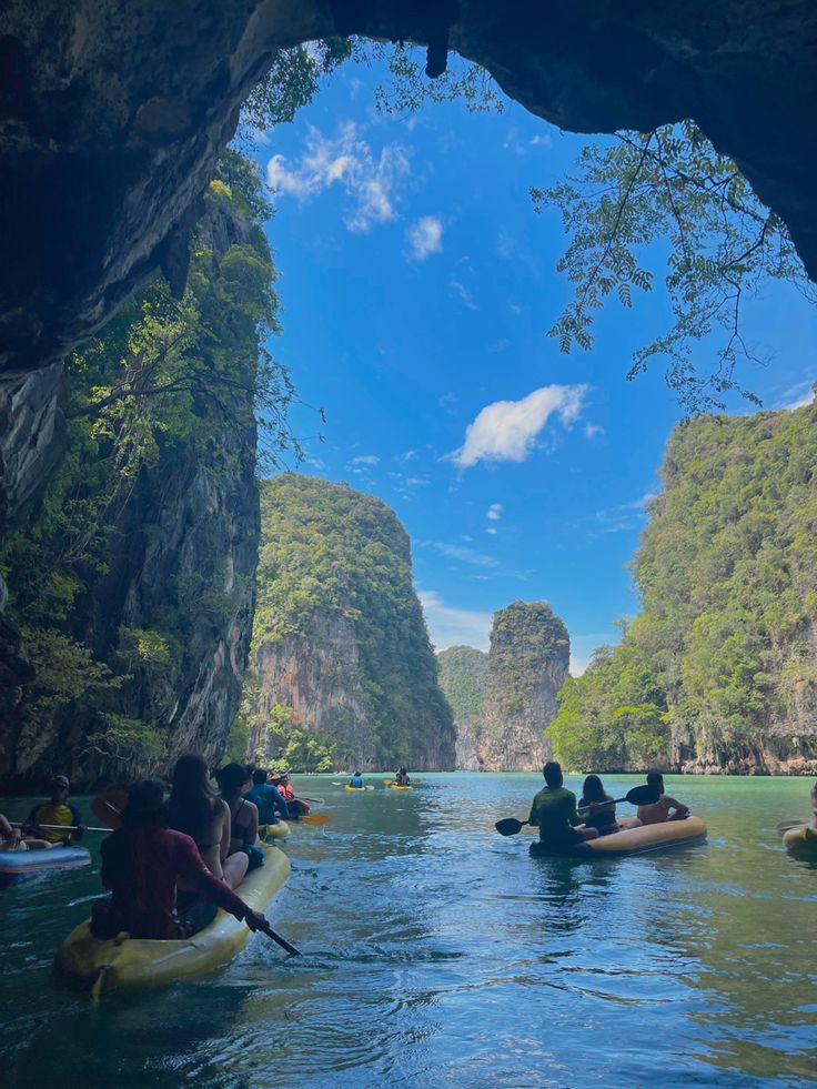 several people in kayaks paddling through a cave