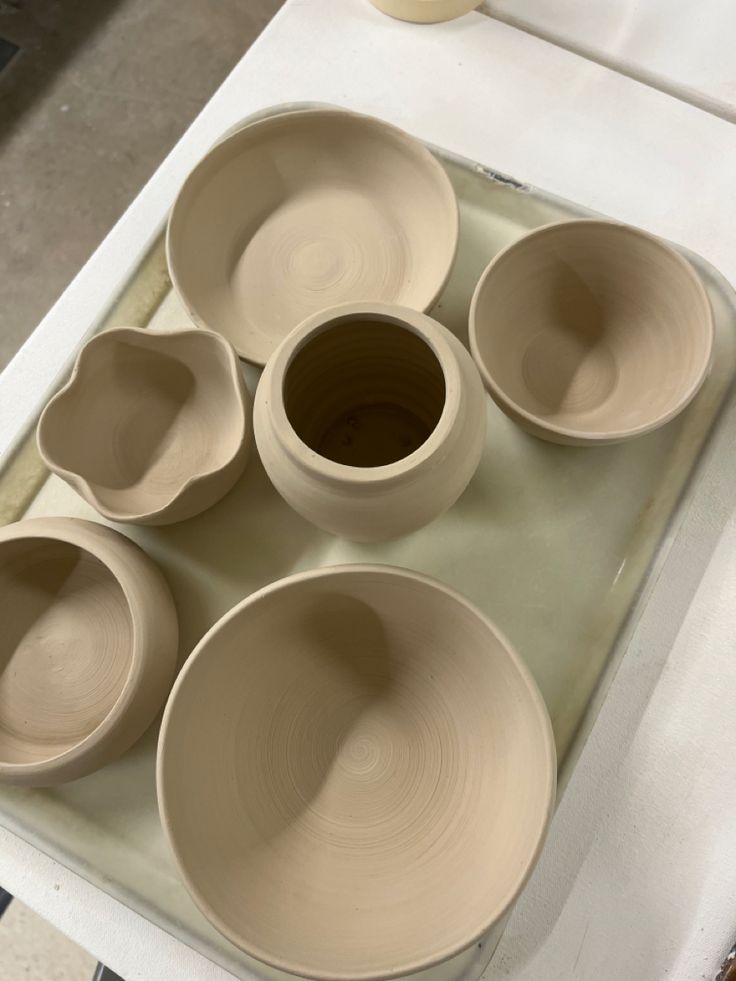 several bowls are arranged on a tray