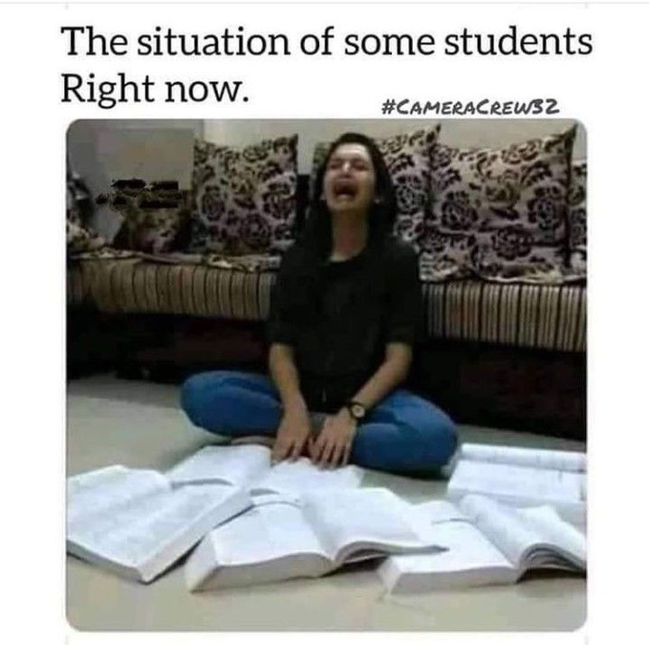 a woman is sitting on the floor with books in front of her and she has an open book