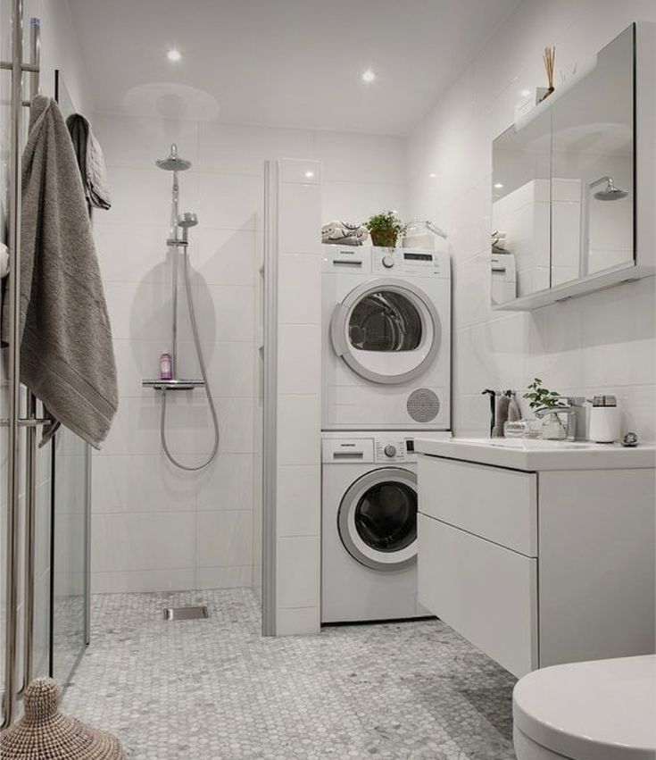 a bathroom with a washer and dryer in it