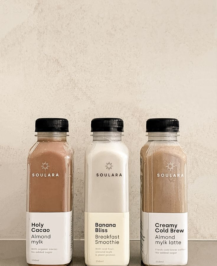 three different types of smoothies on a counter