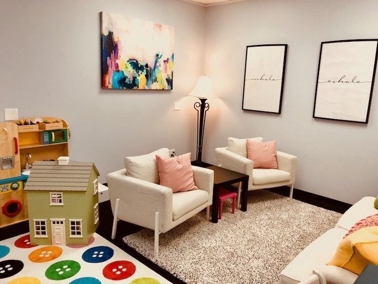 a living room with two chairs and a rug in front of the couches on the floor