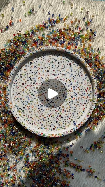 a white bowl filled with lots of colorful sprinkles on top of a table