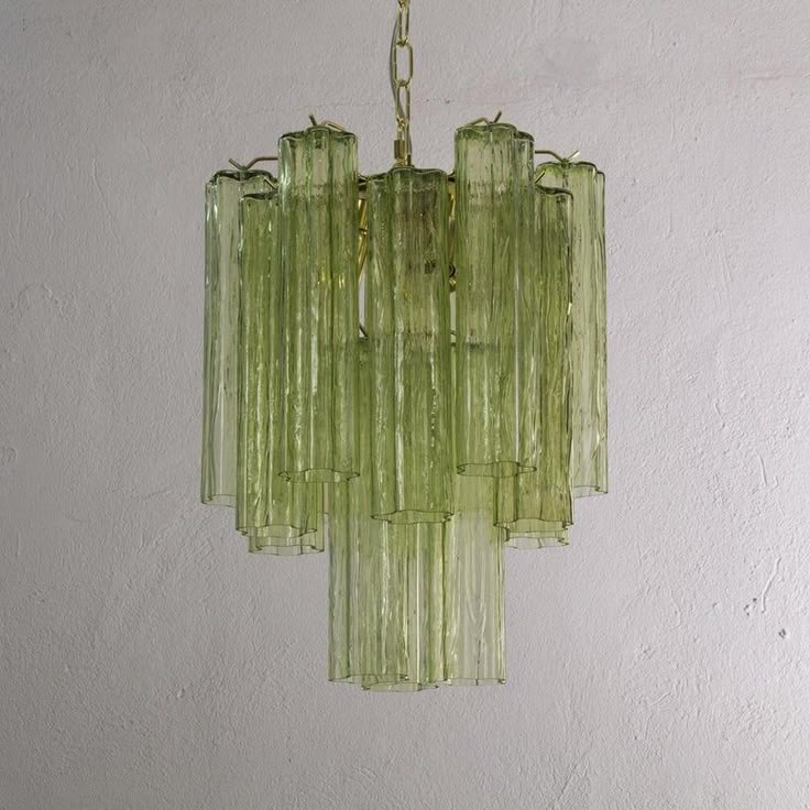 a green glass chandelier hanging from a ceiling