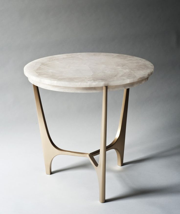 a white marble table with gold legs