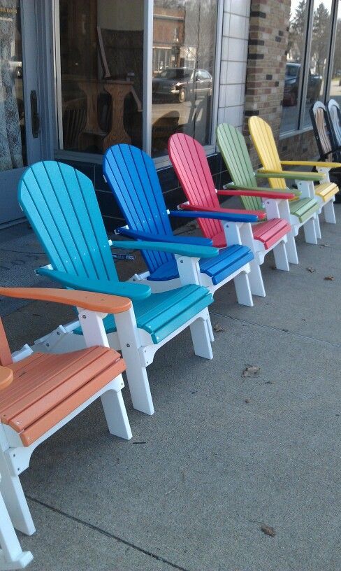 colorful chairs lined up in front of a store