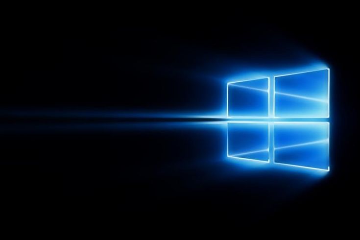 the windows logo is shown in this dark background with blue light coming from behind it