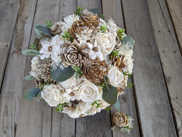 a bridal bouquet with pine cones and flowers